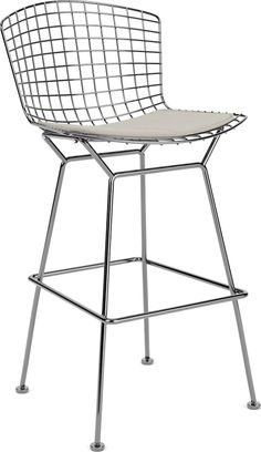 a white chair with metal legs and a seat cushion on it's backrest