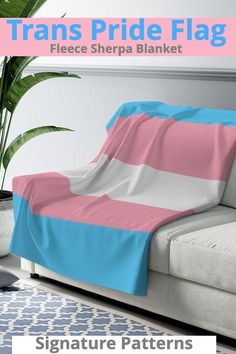 there is a couch with a pink and blue blanket on it