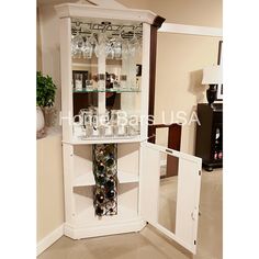 a white cabinet with wine glasses in it