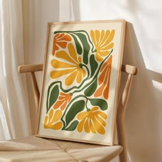 a wooden chair sitting next to a window with a painting on it's back