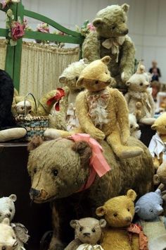 several teddy bears are on display in a room full of other stuffed animals and toys