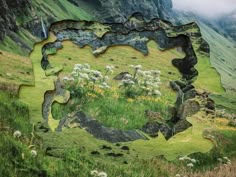 an image of a landscape made out of rocks and grass with mountains in the background