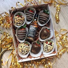 a box filled with chocolate covered strawberries and nuts