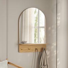 a mirror and coat rack in a white room