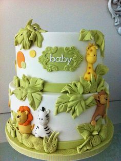 a baby shower cake decorated with jungle animals