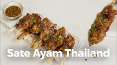 some food is sitting on a plate with the words safe ayen thailand above it