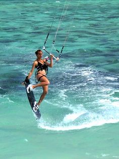 a woman is para sailing in the ocean