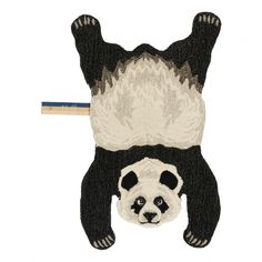 a black and white panda bear with a sweater on it's head is hanging upside down