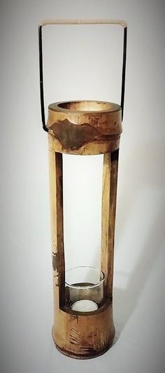 an old wooden lantern with glass inside on a white background, it is empty and ready to be used as a candle holder