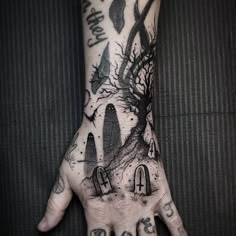 a person's hand with some tattoos on it