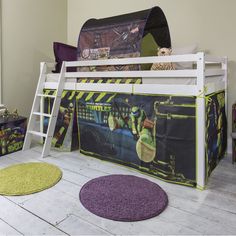 a child's loft bed with teenage mutant beds and rugs on the floor