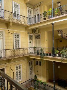 an apartment building with balconies and plants on the balcony