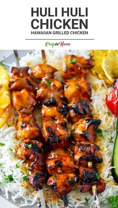 chicken kabobs on skewers with rice and cucumbers in the background