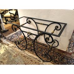 a wrought iron shelf is shown on the floor