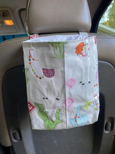 a car seat with a bag hanging from it's side