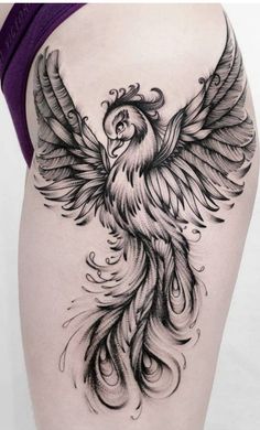 a woman's thigh with a bird tattoo on it