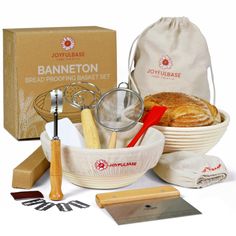 an assortment of breads and pastry items in a basket with a bag next to it