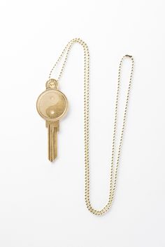 a gold key is attached to a chain