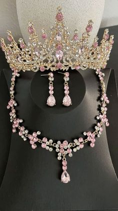 a tiara with pink and white flowers on it sitting on top of a table