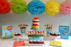 a dr seuss birthday party complete with cake, candy and books on the table