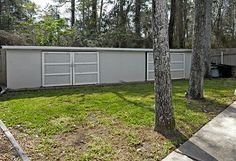 the back yard is fenced off by trees