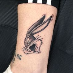 a rabbit tattoo on the leg of a woman