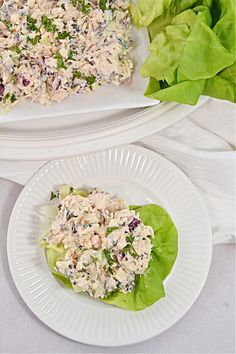 two plates filled with salad and lettuce next to each other