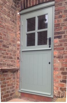 an image of a grey door on a brick building