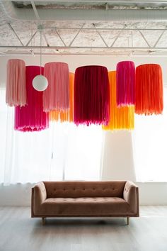 a living room filled with furniture and lots of colorful lights hanging from the ceiling above