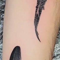 a small lizard tattoo on the left thigh and right leg, it looks like an alligator