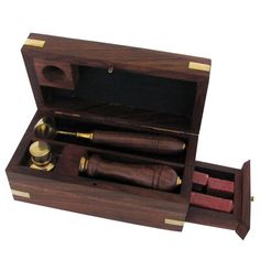 a wooden box with two pens and an ink roller in it's holder,