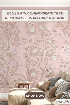 a living room with pink wallpaper and furniture in front of the wall is a couch