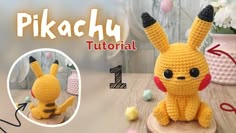 a crocheted pikachu sitting on top of a wooden table next to a vase