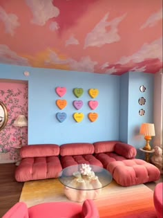 a living room with pink and blue walls, hearts painted on the ceiling and furniture