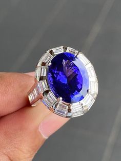 Luxury Tanzanite Sapphire Ring For Promise, Luxury Tanzanite Gemstone Diamond Ring, Luxury Tanzanite Ring With Bezel Setting, Luxury White Gold Tanzanite Jewelry, What Should I Write About, Tanzanite And Diamond Ring, How To Explain, Baguette Diamond Ring, Tanzanite Engagement Ring