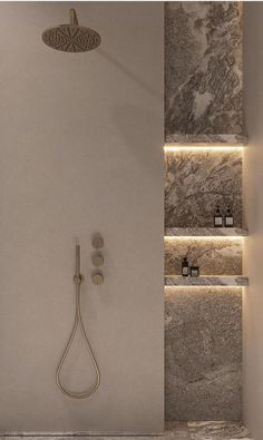 a bathroom with a shower head and lights on the wall, along with two shelves