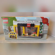 the box is open to show the inside of the lego store front and its contents