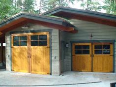 two garages with wooden doors in front of them