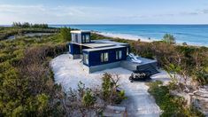 an aerial view of a house on the beach