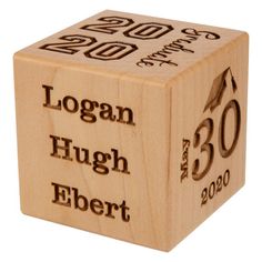 a wooden cube with the words logan, hugh and ebert printed on it