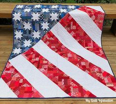 an american flag quilt on a wooden bench