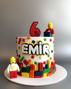 a birthday cake decorated with legos and the number six for an individual's 6th birthday