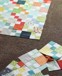 two pieces of quilt sitting on the floor next to each other, with one piece missing