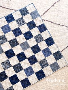 a blue and white quilt on the ground