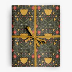 a gift box wrapped in brown paper with yellow ribbon and floral pattern on the front