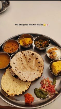 a metal plate topped with different types of food