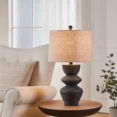 a table lamp sitting on top of a wooden table