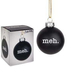 a black ornament with the word men hanging from it's side in front of a box