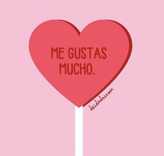 a heart shaped lollipop with the words me gustas mucho on it