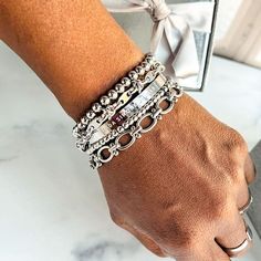 Give yourself options with the Chrisette Bracelet Stack. This bracelet stack features five dainty bracelets that are designed to mix and match for an assortment of styles. Wear just one, two or three - or stack them all for an extra pop! This braclet stack includes: - Nakia stainless steel beaded bracelet (4mm and 6mm) - Jada stainlesss steel bracelet - Lily stainless steel bracelet - Darla stainless steel bracelet Fits wrists up to 7.5 inches Bracelet size guide Silver Bracelet Stack, Bracelet Stacks, Stacked Earrings, Stackable Bracelets, Dainty Bracelets, Anklet Bracelet, Silver Pieces, Watch Necklace, Arm Candy